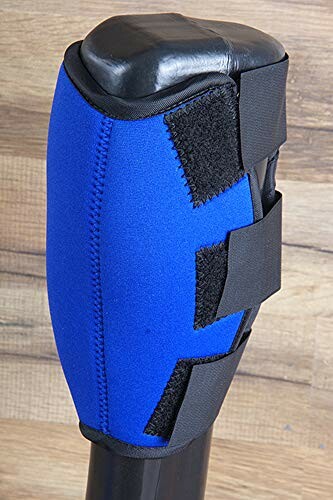 Blue knee pad with black straps on wooden background